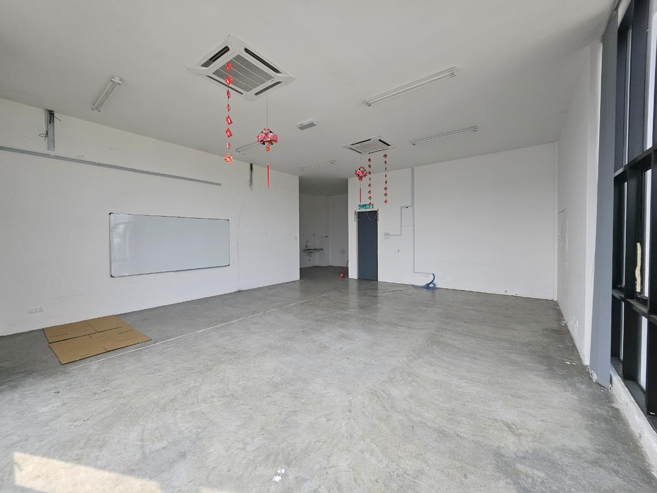 Unoccupied office interior with ceiling air conditioning and large windows