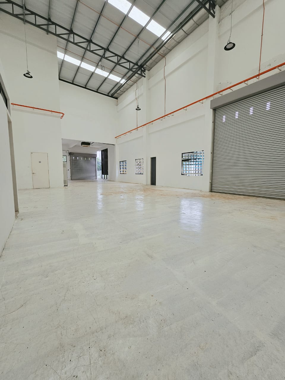 Factory interior with high roof and roller shutter doors